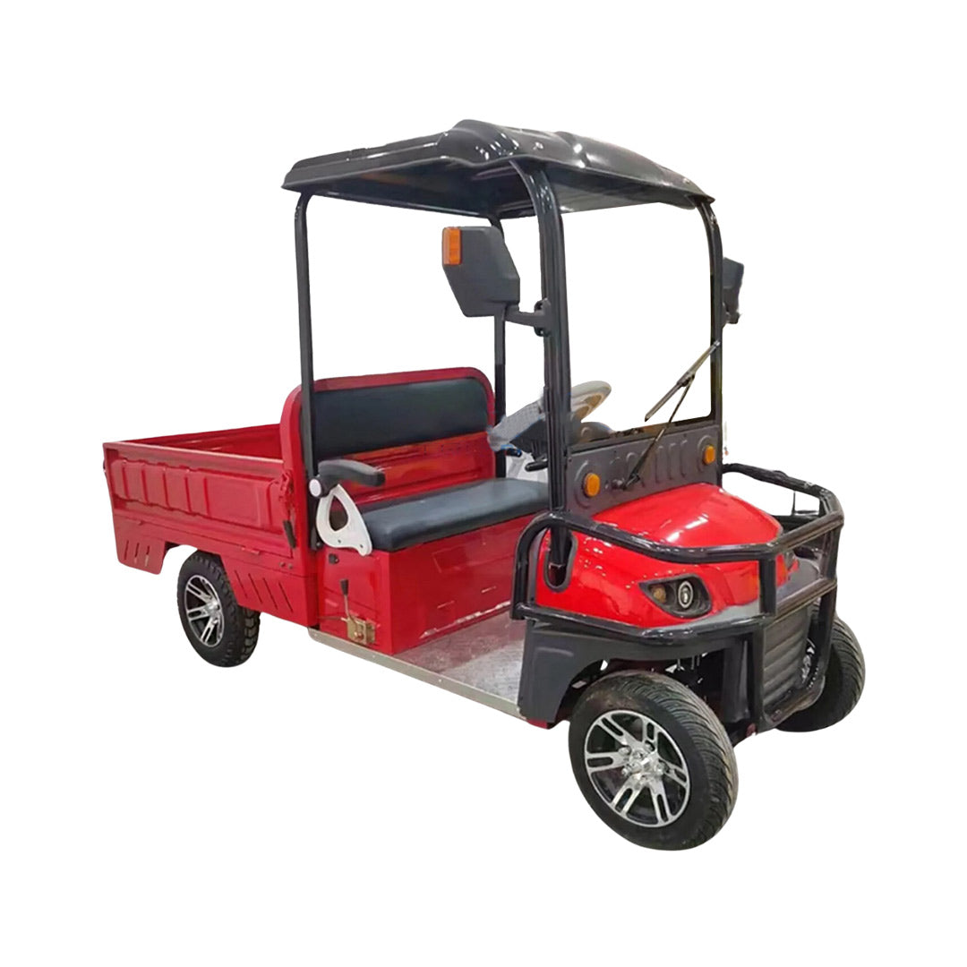 ocean cartz three-quarter front studio shot of a red utility electric vehicle with a short flatbed, set against a pure white background. This two-seater electric work cart features a black roof, black seats, a robust black front brush guard, and a small windshield with a wiper. The electric utility truck has custom silver alloy wheels and is designed for commercial hauling and property maintenance tasks.