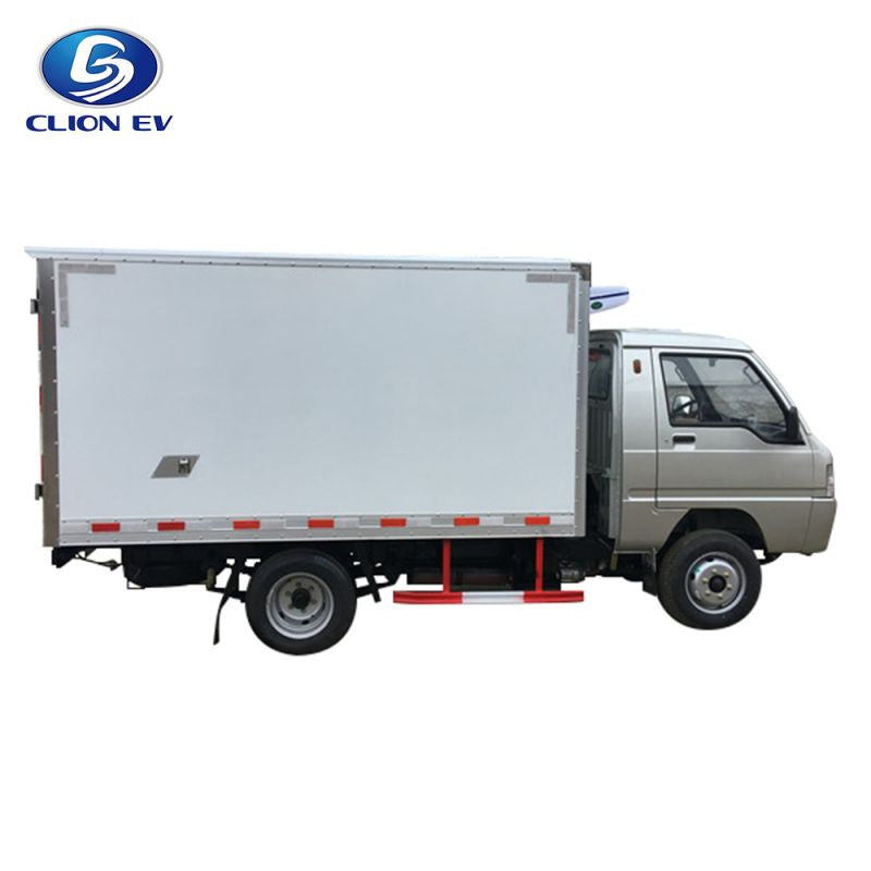 ocean cartz side profile studio shot of a silver electric refrigerated truck with a large, white insulated cargo box, set against a pure white background. This specialized electric commercial vehicle is a refrigerator delivery van designed for transporting temperature-sensitive goods, featuring a driver's cab and a side reflective safety strip along the bottom of the box.