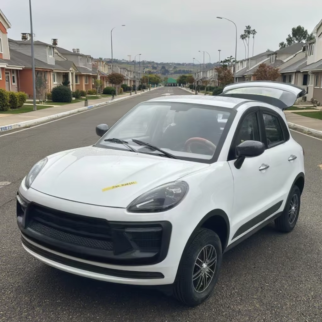 White car with a gull-wing door open on a residential street