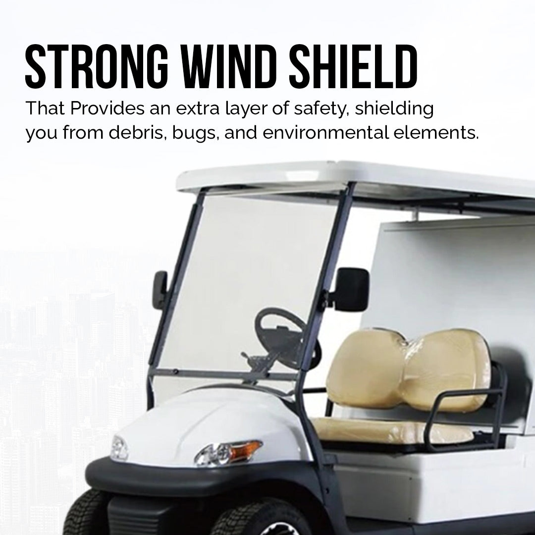 ocean cartz promotional image highlighting the strong windshield of a white utility golf cart with a rear storage cabinet. The image focuses on the clear, full-height windshield, with text promoting its role in shielding against debris, bugs, and environmental elements for safety. The two-seater electric work cart features tan seats and a white roof, emphasizing a key safety feature for this service vehicle.