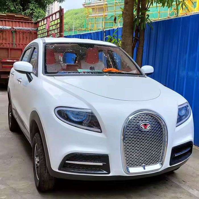White SUV parked on a street with a blue wall and tree in the background