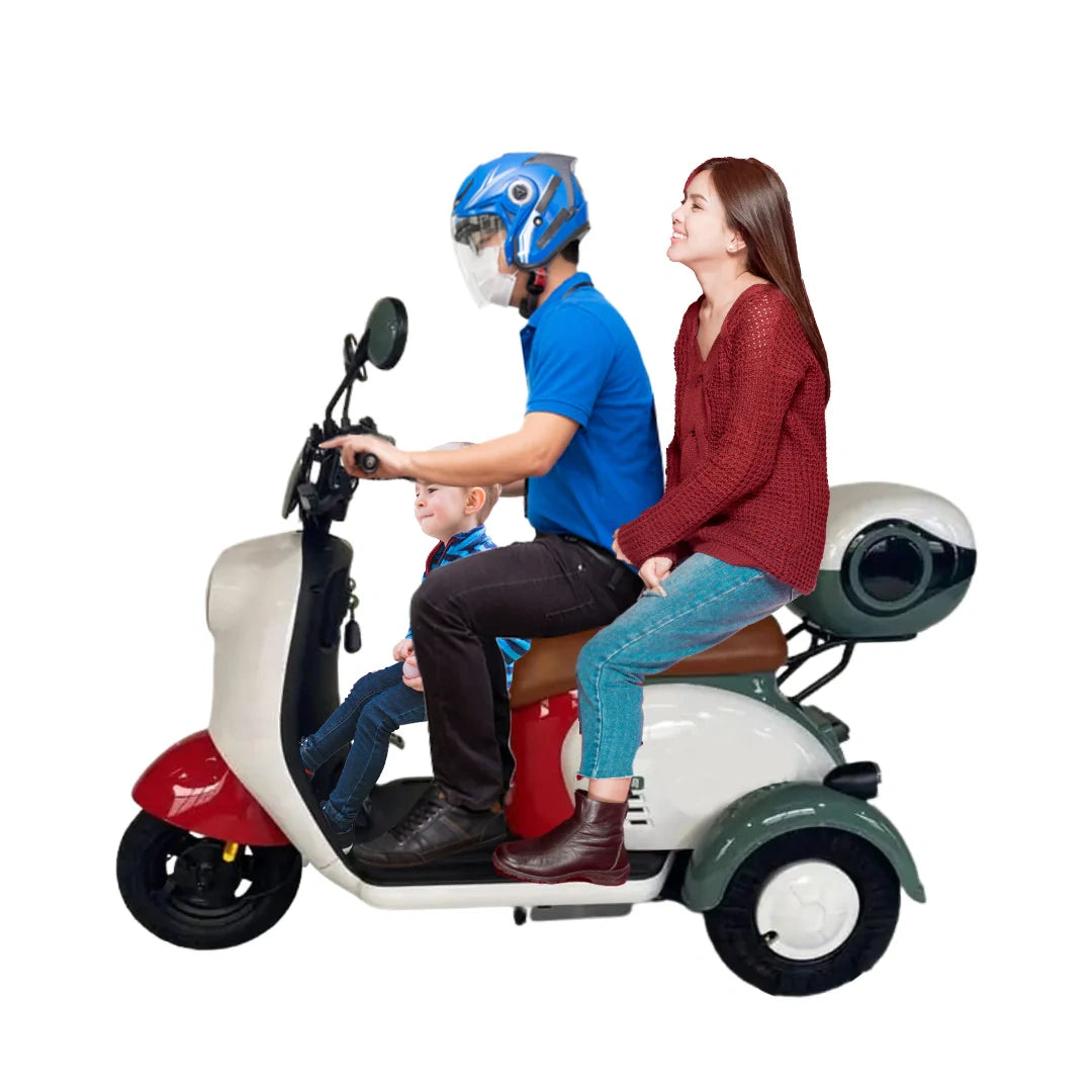 ocean cartz family riding a three-person electric scooter with a white, red, and teal color scheme. The image shows an adult couple and a child, highlighting the spacious seating and capability of this multi-passenger electric mobility vehicle for family transport and city commuting.