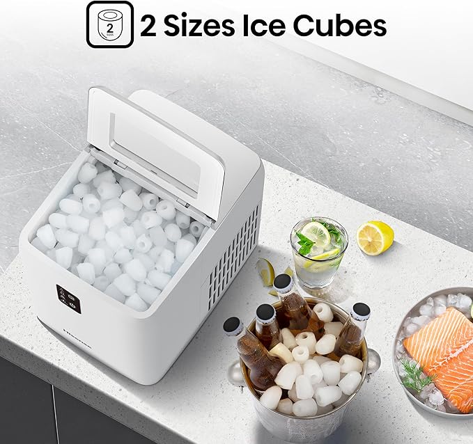 Ice maker with ice cubes on a countertop next to drinks and food items.