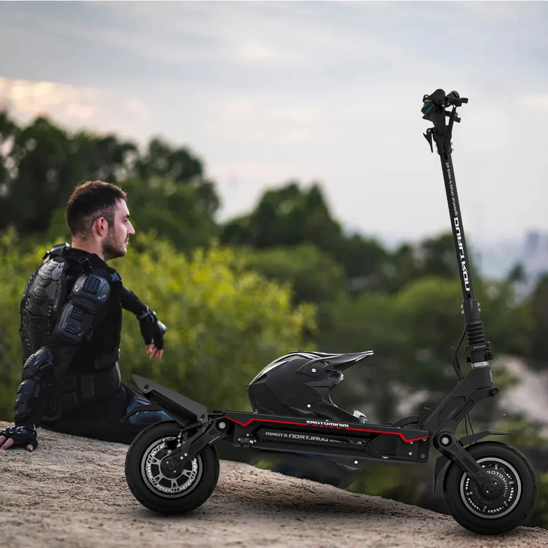 Person sitting on a rock with a folded electric scooter in a natural setting