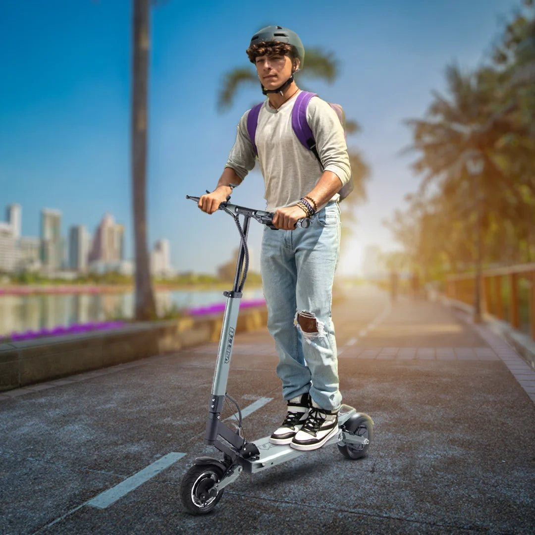 Person riding an electric scooter with a cityscape and palm trees in the background