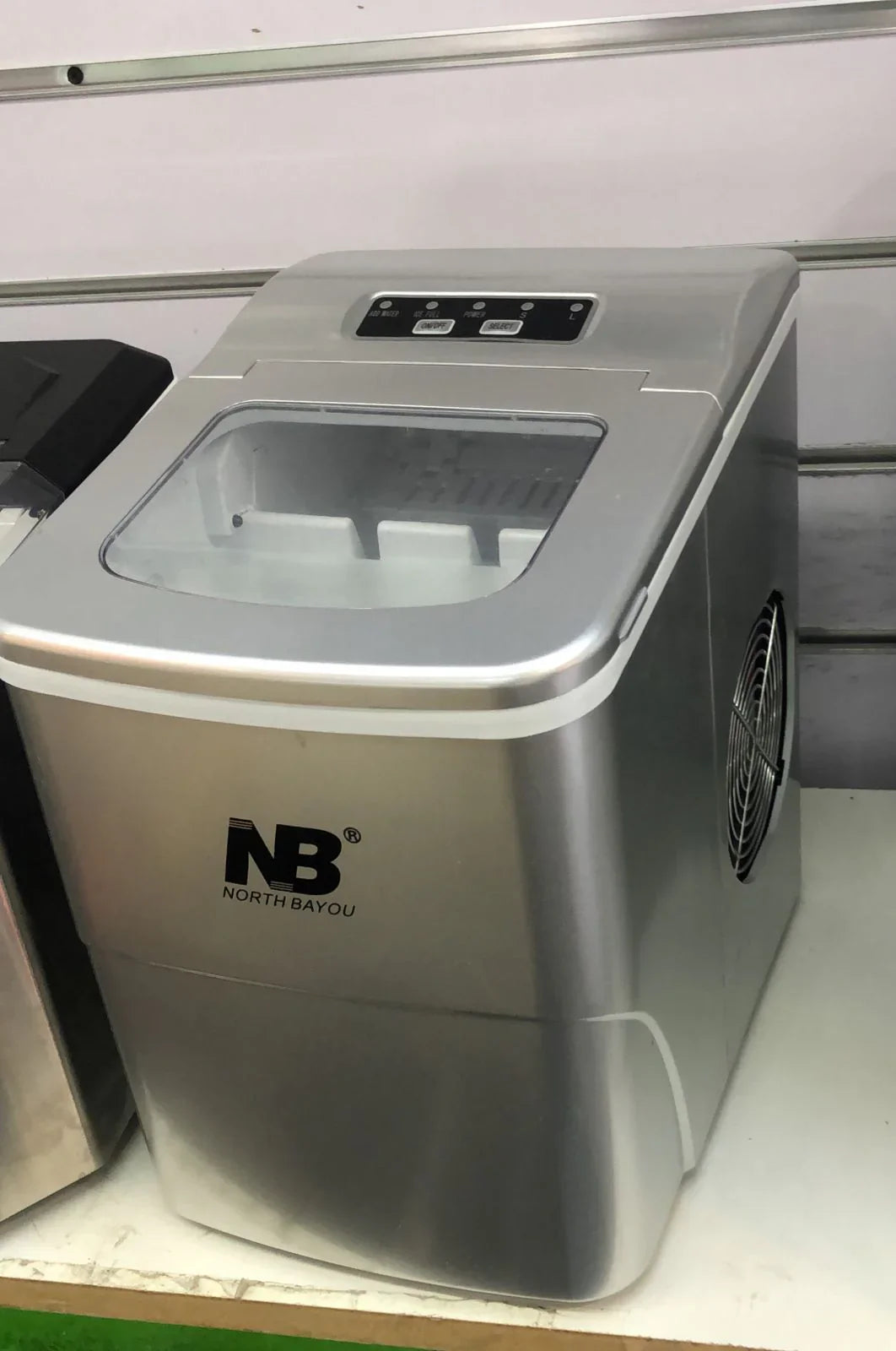 Portable ice maker with NB logo on a white surface