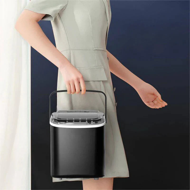 Person holding a black trash can against a dark background