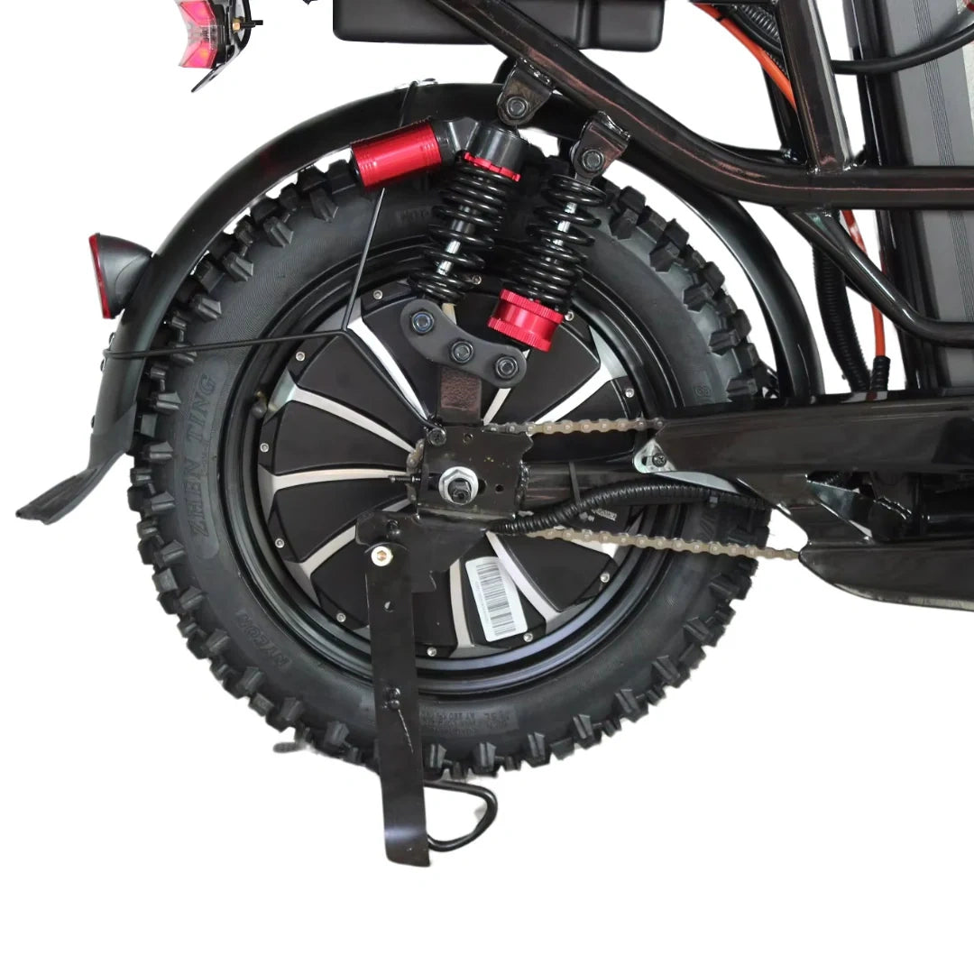 Close-up of a motorcycle wheel with suspension and chain mechanism on a white background